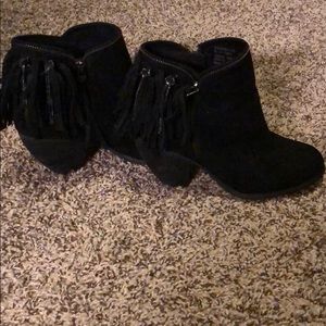 Black booties with tassels.